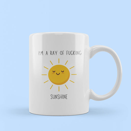 joke mug. rude quote. im a ray of fucking sunshine quote. image of cute, happy sun.